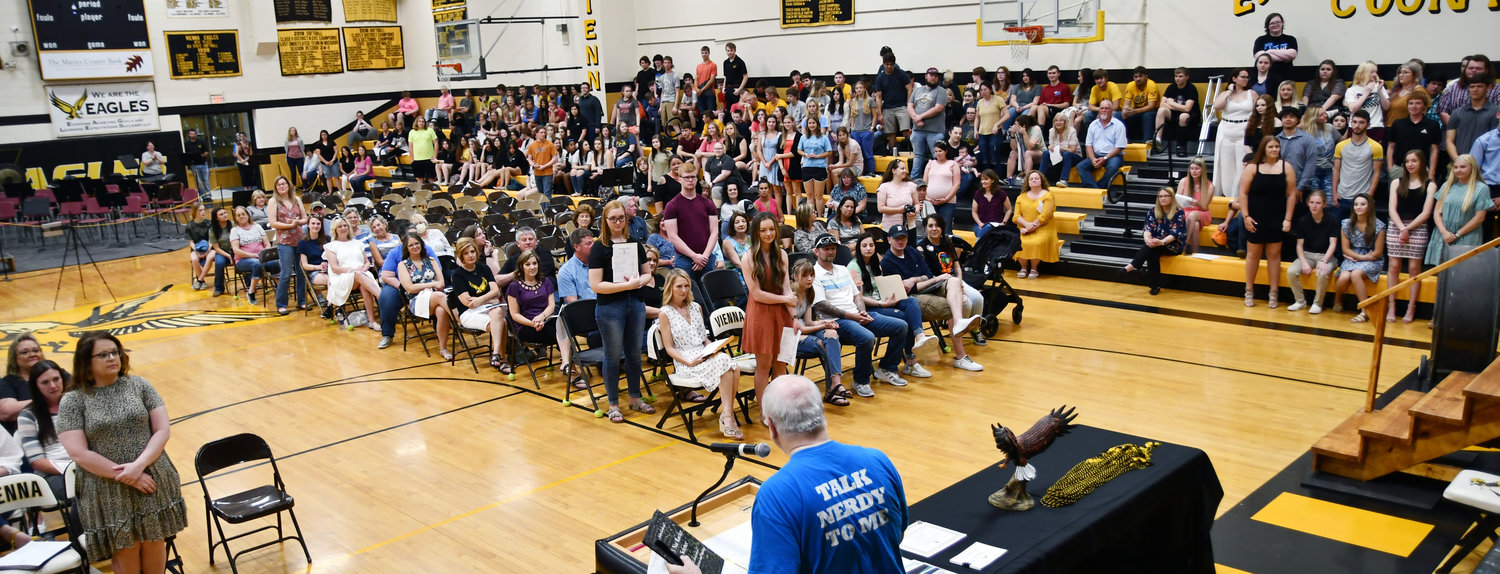 Current and former students of John Kinkead stand during the presentation.